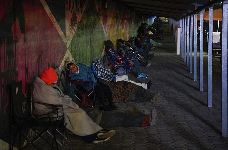 At the pedestrian crossing people sleep in line waiting for the border to open. People have been sleeping in their cars at the Otay border to wait for the port of entry to open; it started happening after the hours of service of the border port of entry were reduced. (Alejandro Tamayo/The San Diego Union Tribune/TNS)