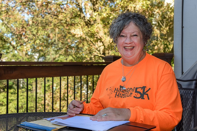 Julie Smith/News TribuneTheresa McClellan is shown seated on her back porch where she was interviewed for an article about her involvement in The Sneaker Project, where she serves as executive director.