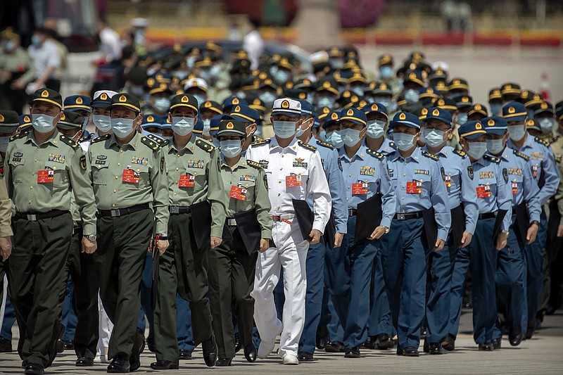 FILE - In this May 28, 2020, file photo, military delegates arrive for the closing session of China's National People's Congress (NPC) at the Great Hall of the People in Beijing. Defense officials from China and the U.S. have held two days of talks in a small sign of progress amid a continuing sharp downturn in relations. (AP Photo/Mark Schiefelbein, File)