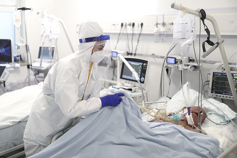 A member of the medical staff attends to a patient at the COVID-19 ICU unit of the Dr. Abdulah Nakas General Hospital in Sarajevo, Bosnia, Friday, Sept. 24, 2021. Public mistrust of authorities in corruption-plagued Bosnia has created an opening for anti-vaccination movement even though the Balkan nation has the highest rate in Europe of coronavirus deaths and faces a growing number of new infections. So far, despite an abundance of coronavirus vaccines in Bosnia, just under 13 percent of its 3.3 million people had been fully immunized against Covid-19. (AP Photo)