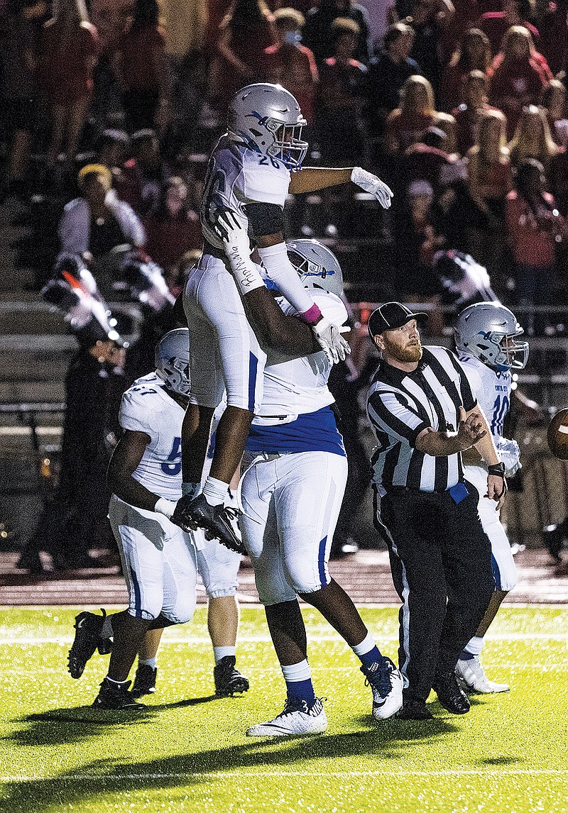 Capital City's Cortez Wilder is lifted in the air in celebration following his touchdown run during last Friday night's game against Jefferson City at Adkins Stadium.