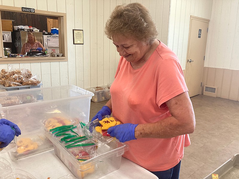 Elaine Leslie, a volunteer with the Holts Summit Soup Kitchen, packages sorted cookies to be handed out at their meal Sept. 7 at the Civic Center in Holts Summit. The soup kitchen provides 130-150 free meals every Tuesday and Thursday. (Garrett Fuller/News Tribune)