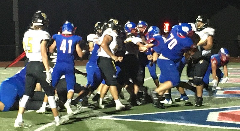 <p>Democrat photo/Evan Holmes</p><p>The Pintos charge onto the field amidst a crowd of waves, cheers and fireworks ahead of Friday’s Homecoming clash against Versailles.</p>