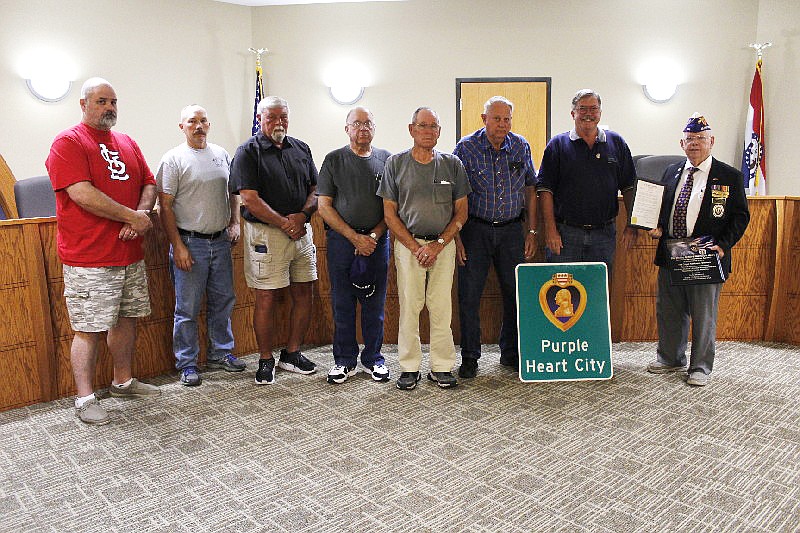 Marine veteran and Purple Heart recipient Walt Schley, pictured here at the far right, was on hand at Monday's Board of Aldermen meeting as California was officially designated as a Purple Heart City. Here, Schley is joined by California Mayor Rich Green and other veterans in attendance.