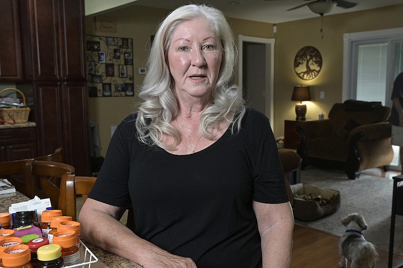 Retiree Donna Weiner shows the daily prescription medications that she needs and pays over $6,000 a year through a Medicare prescription drug plan at her home, Tuesday, Oct. 5, 2021, in Longwood, Fla. Weiner supports giving Medicare authority to negotiate drug prices. Negotiating Medicare drug prices is the linchpin of President Joe Biden's ambitious health care agenda. Not only would consumers see lower costs, but savings would be plowed into other priorities such as dental coverage for retirees and lower premiums for people with plans under the Obama-era health law. (AP Photo/Phelan M. Ebenhack)