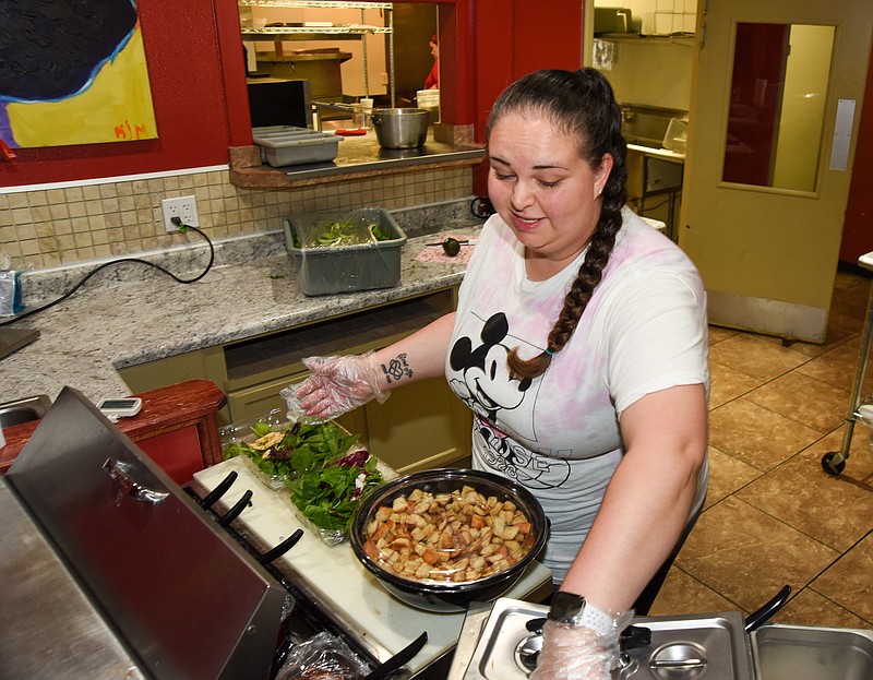 Martina Miller makes multiple salads for delivery Wednesday, Oct. 6, 2021, during the lunch hour. Miller originally opened Salad Slingers in the La Chica Loca commissary kitchen in downtown Jefferson City, then later moved the business to the Lincoln University campus. (Julie Smith/News Tribune photo)