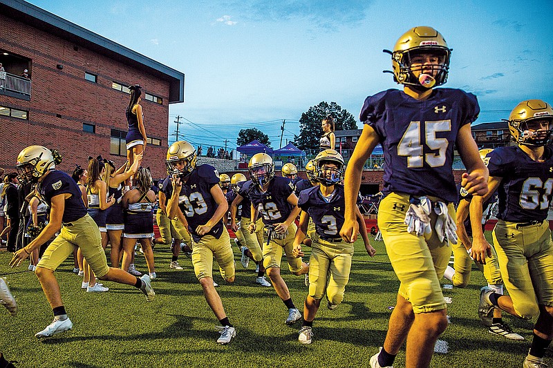  The Helias Crusaders take the field prior to last Friday night's game against the Capital City Cavaliers at Ray Hentges Stadium.