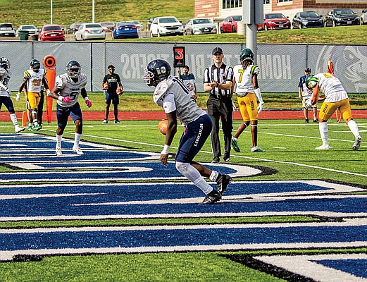 Lincoln quarterback Zamar Brake celebrates after running for a touchdown in Saturday's game against Missouri Southern at Dwight T Reed Stadium.