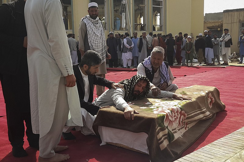 Relatives and residents attend a funeral ceremony for victims of a suicide attack at the Gozar-e-Sayed Abad Mosque in Kunduz, northern Afghanistan, Saturday, Oct. 9, 2021. The mosque was packed with Shiite Muslim worshippers when an Islamic State suicide bomber attacked during Friday prayers, killing dozens in the latest security challenge to the Taliban as they transition from insurgency to governance. (AP Photo/Abdullah Sahil)