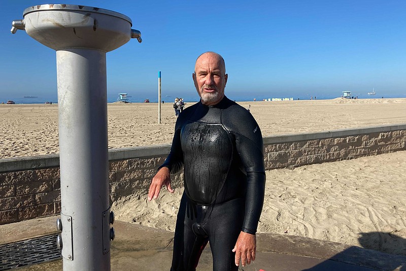 Richard Beach, 69, of Huntington Beach, Calif., said he was told to leave the ocean by lifeguards after he returned to the waves to bodyboard in Huntington Beach, Calif., Sunday, Oct. 10, 2021. The water has been closed to surfing and swimming for a week since an offshore oil pipeline leaked crude into the water off the coast of Orange County. (AP Photo/Amy Taxin)