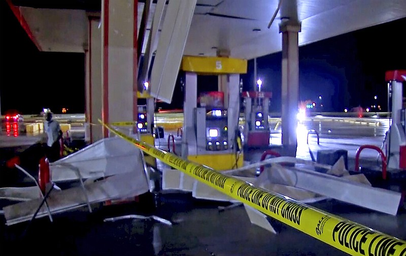 In this image made from video, debris from tornadoes pile around the pumps of a filling station late Sunday, Oct. 10, 2021, in Shawnee, Oklahoma. Several reported tornadoes ripped through Oklahoma late Sunday into early Monday morning, causing damage. (KWTV via AP)
