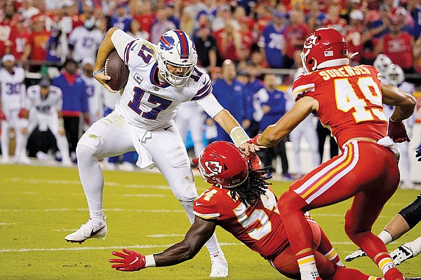 Bills quarterback Josh Allen tries to avoid the tackle attempts of Chiefs linebacker Nick Bolton and safety Daniel Sorensen during Sunday night's game at Arrowhead Stadium.