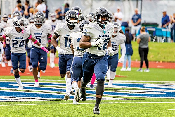 Lincoln senior TeAndre Skinner leads the Blue Tigers onto the field for Saturday afternoon's Homecoming game against Missouri Southern at Dwight T. Reed Stadium.