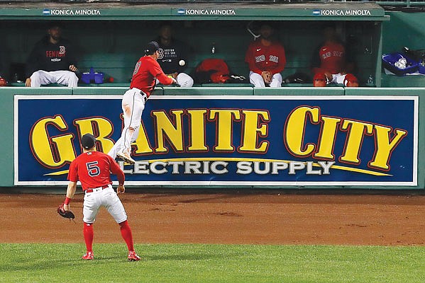 Red Sox right fielder Hunter Renfroe leaps as the ball, hit by Kevin Kiermaier of the Rays, bounces over the wall for a ground rule double in the 13th inning of Sunday night's Game 3 of the American League Division Series in Boston.