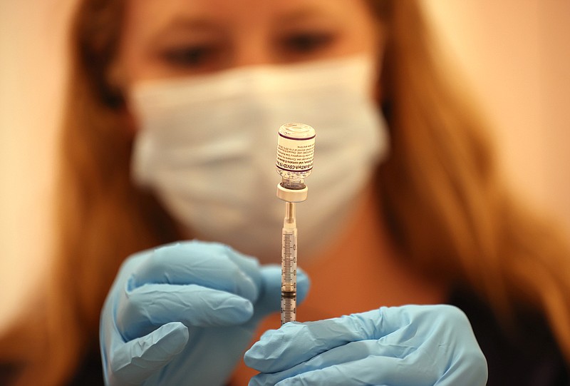 Safeway pharmacist Ashley McGee fills a syringe with the Pfizer COVID-19 booster vaccination at a vaccination booster shot clinic on Friday, Oct. 1, 2021 in San Rafael, California. (Justin Sullivan/Getty Images/TNS)