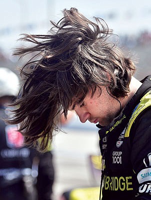 Colton Herta flips his hair after climbing from his race car following qualifying last month for the IndyCar Grand Prix of Long Beach in Long Beach, Calif.