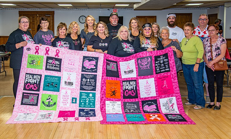 <p>News Tribune file</p><p>Quilts containing T-shirts from previous Community Breast Care Project Ride for the Ribbon events are presented Oct. 2 to the family of Lorie Smith, the former CBCP director who died unexpectedly last year.</p>