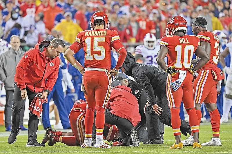 Chiefs quarterback Patrick Mahomes and wide receiver Tyreek Hill look down as injured teammate running back Clyde Edwards-Helaire receives treatment during Sunday night's game against the Bills at Arrowhead Stadium.