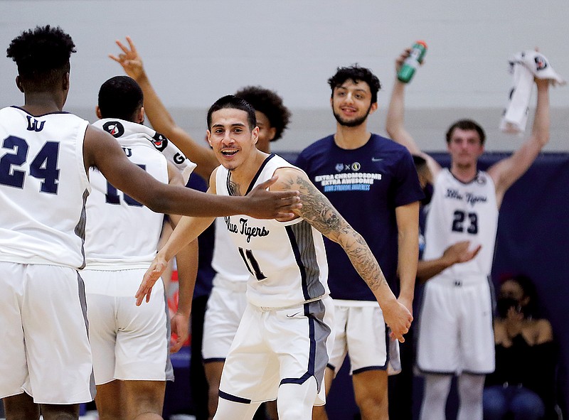 Yaniel Vidal congratulates Lincoln teammates during a game last season against Newman at Jason Gym.