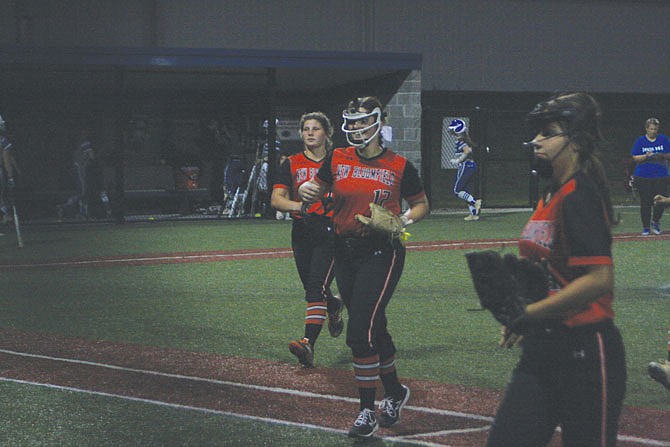 Sophomore pitcher Peityn Thomas runs off the field with her teammates smiling Wednesday night in the Lady Wildcats' 5-1 district semifinal win against Montgomery County in Mokane. New Bloomfield had much to smile about with Thomas striking out 13 and the defense making the plays behind her.