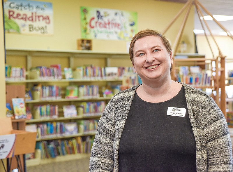 <p>Julie Smith/News Tribune</p><p>Angie Bayne, manager of Missouri River Regional Library’s Children’s Library, poses in the upstairs area that houses children’s book, games and toys.</p>