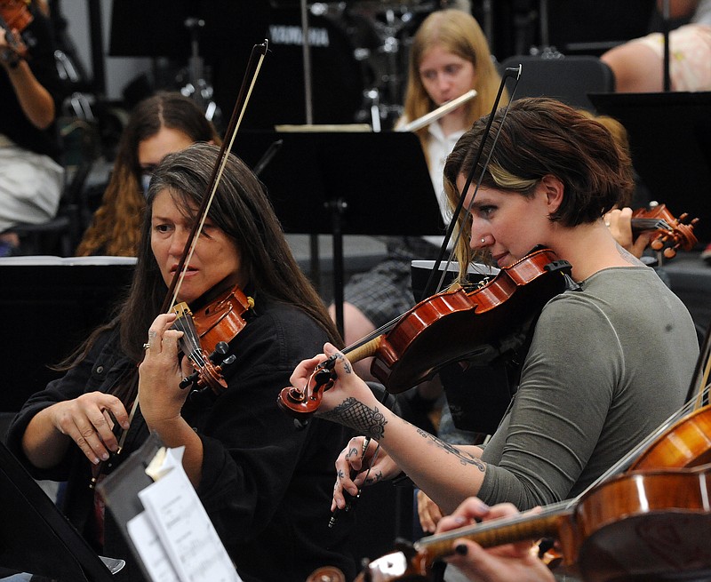 Rebecca Talbert (left) and other members of the Jefferson City Symphony Orchestra practice for the upcoming "Spooktacular" concert. Shaun Zimmerman / News Tribune