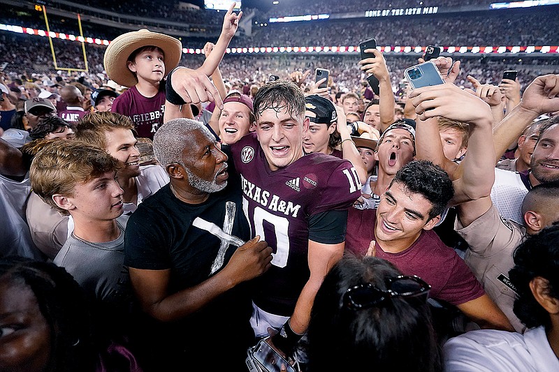 Texas A&M quarterback Zach Calzada is surrounded by fans after last Saturday night's win against Alabama in College Station, Texas.