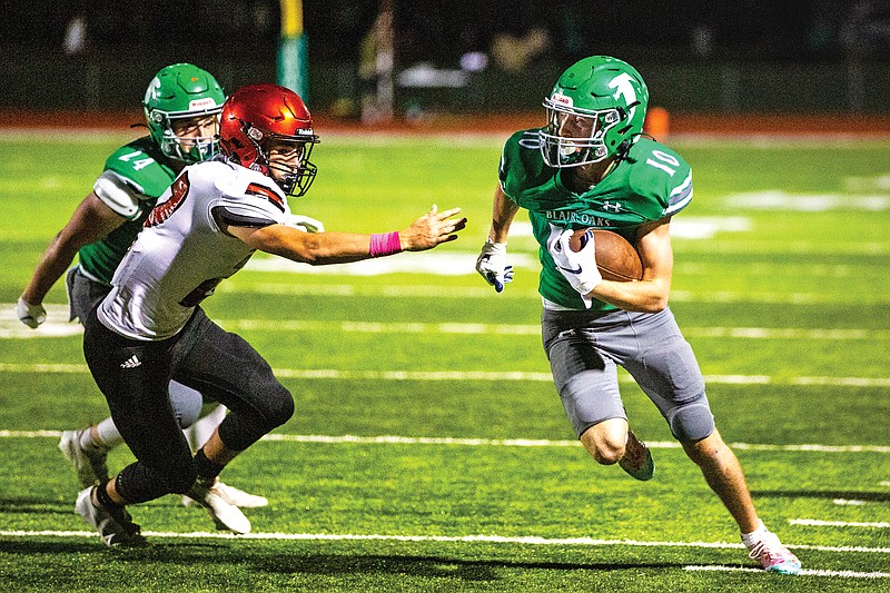 Blair Oaks wide receiver Zach Herigon dodges past Southern Boone defensive back Bradly Smith Oct. 15, 2021, at the Falcon Athletic Complex in Wardsville.