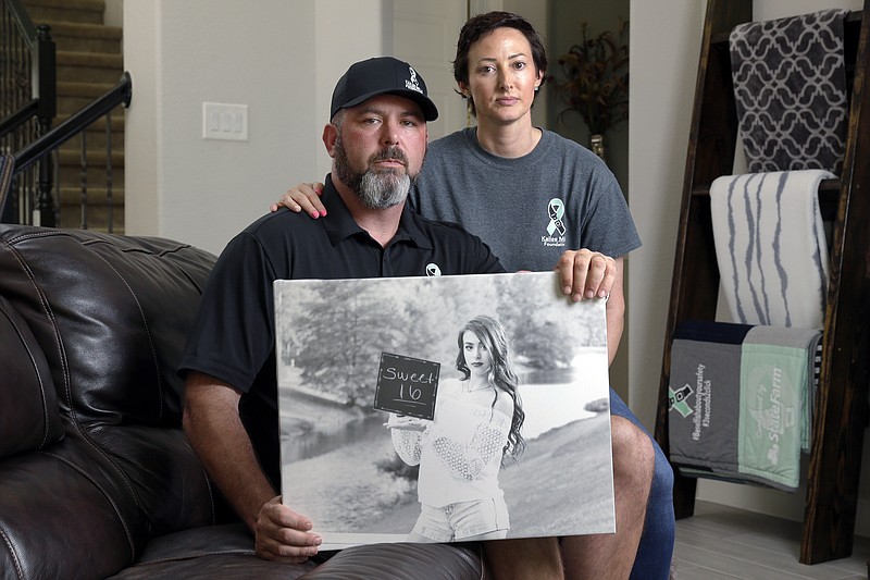<p>AP</p><p>David and Wendy Mills, parents of Kailee Mills, who was killed four years ago in an automobile accident when riding in the back seat without a seat belt, with a photo of their daughter at their home in Spring, Texas. The teenager was riding in the back seat of a car to a Halloween party in 2017 just a mile from her house when she unfastened her seat belt to slide next to her friend and take a selfie. Moments later, the driver veered off the road and the car flipped, ejecting her.</p>