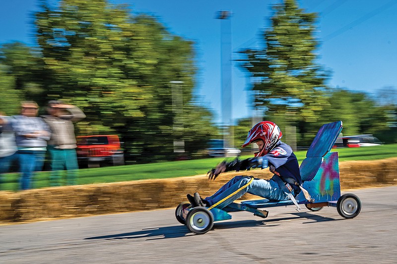 <p>Ethan Weston/News Tribune</p><p>Noah Miller, 9, reaches for the brakes Saturday during the Five Rivers District’s cubmobile races on State Street. “When I’m (racing) I’m thinking about my time and how other people are doing,” Miller said.</p>