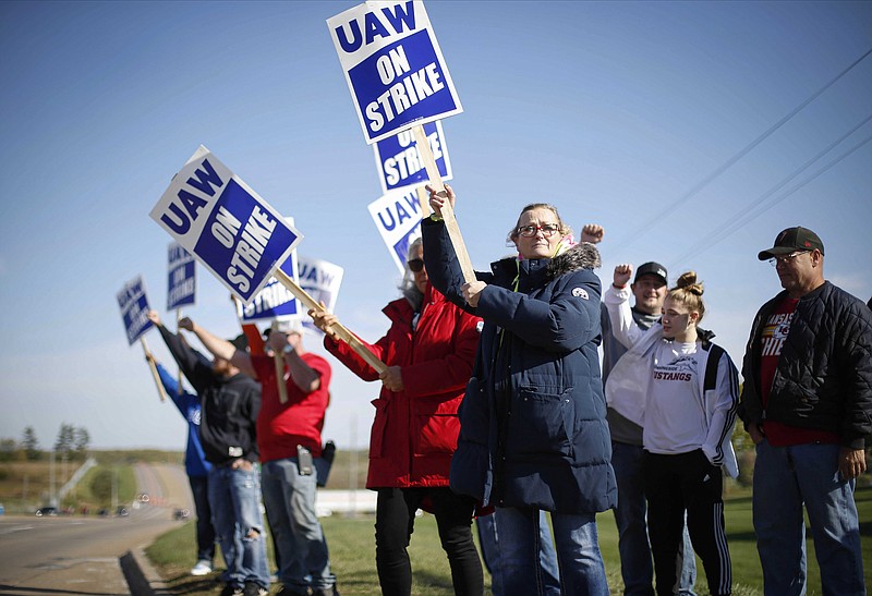 Members of the United Auto Workers strike outside of the John Deere Engine Works plant on Ridgeway Avenue in Waterloo, Iowa, on Friday, Oct. 15, 2021. About 10,000 UAW workers have gone on strike against John Deere since Thursday at plants in Iowa, Illinois and Kansas.(Bryon  Houlgrave/The Des Moines Register via AP)