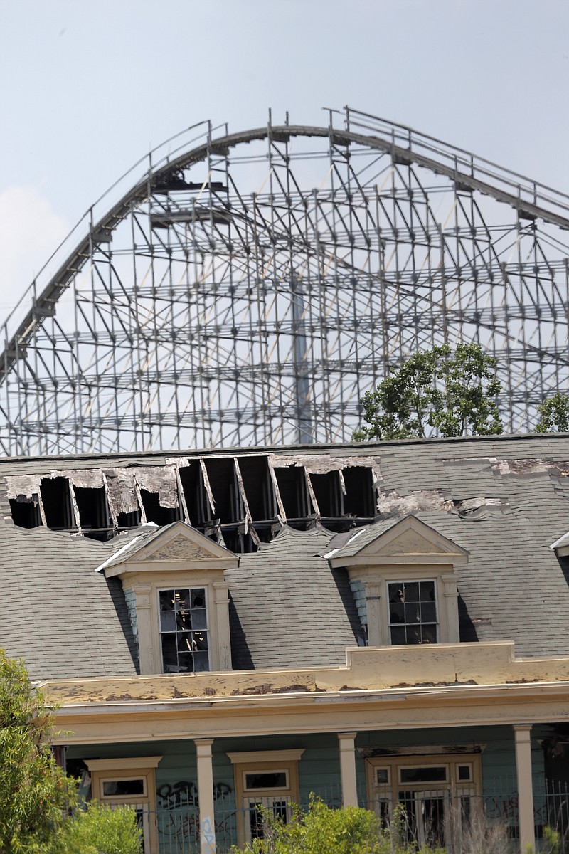FILE - In this June 19, 2019 file photo, the roller coaster and concession buildings of the abandoned Six Flags amusement park are seen in New Orleans. New Orleans has chosen a developer to revitalize the site of a former amusement park in the eastern part of the city that has been vacant since 2005's Hurricane Katrina.. (AP Photo/Gerald Herbert, File)