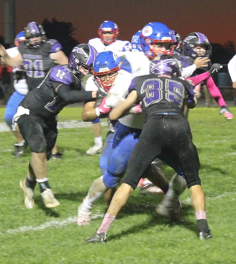 Democrat photo/Evan HolmesSenior running back Enoch Dunnaway pushes his way through multiple defenders for a first down last Friday night.