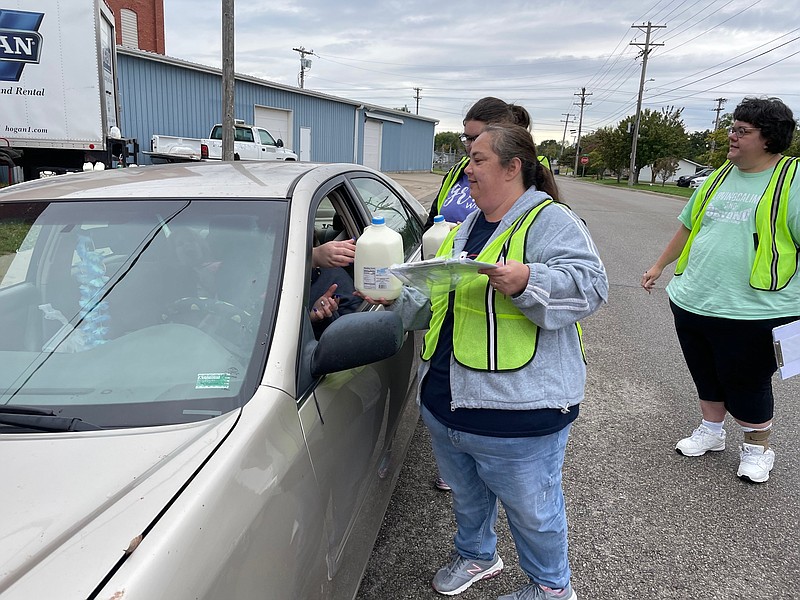 <p>Democrat photo/Kaden Quinn</p><p>New Beginnings volunteer Angie Lee passes out food to families for Free Food Friday.</p>