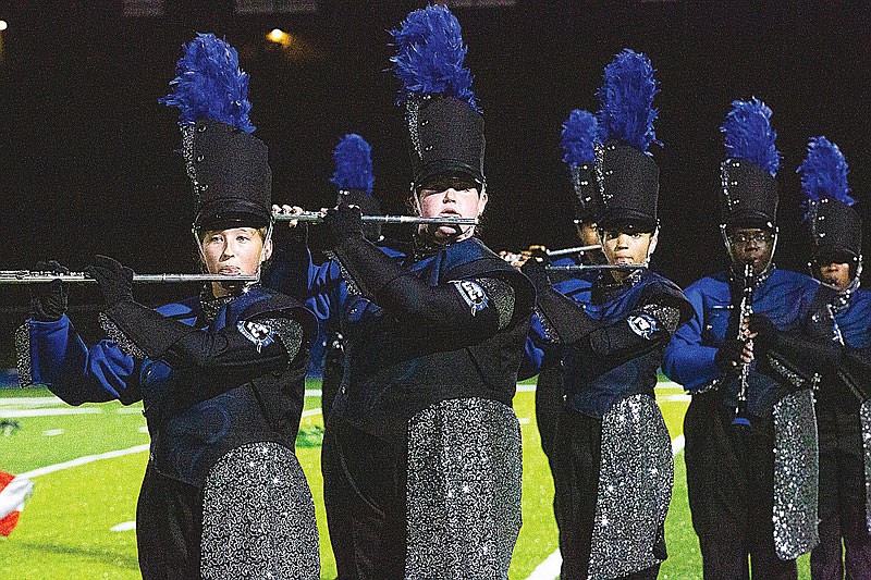 Flautists perform during the Capital City High School marching band's field show of Jekyll and Hyde on Tuesday, Oct. 19, 2021 in Jefferson City, Mo. (Ethan Weston/News Tribune photo)