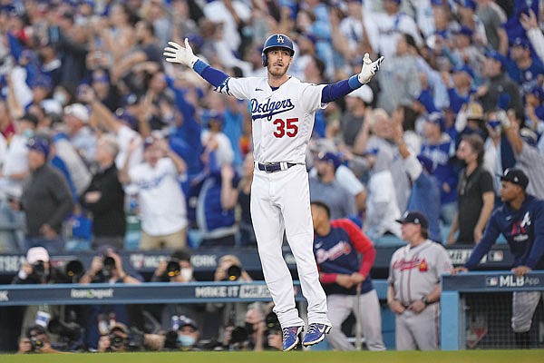 Cody Bellinger of the Dodgers watches his a three-run home run Tuesday during the eighth inning in Game 3 of the National League Championship Series against the Braves in Los Angeles.