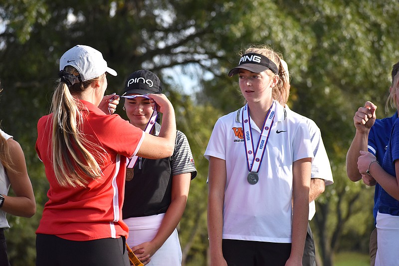 Camryn Swinfard of Jefferson City receivers her medal Tuesday after tying for 12th in the Class 3 state tournament at Meadow Lake Acres Country Club.