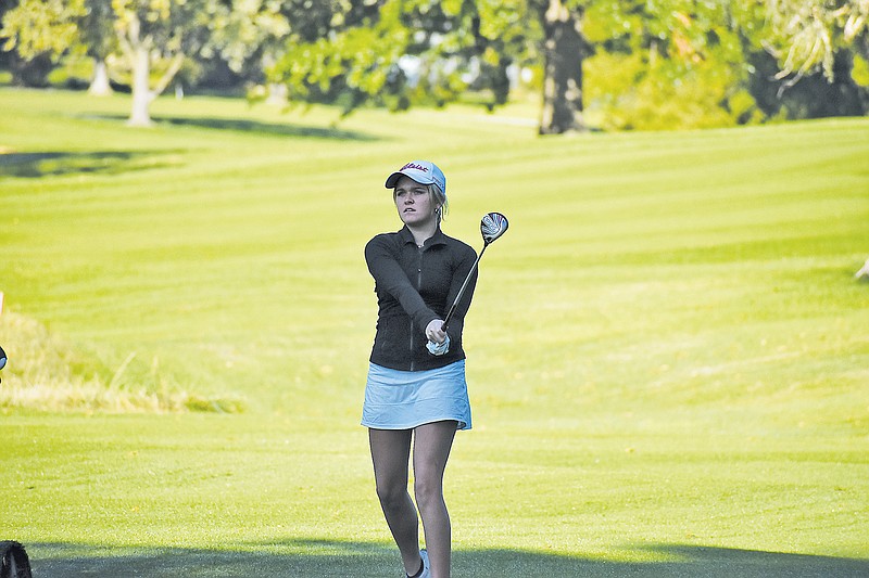 Sophie Hinds of Helias watches her shot during Tuesday's second round of the Class 2 state golf tournament at Columbia Country Club.