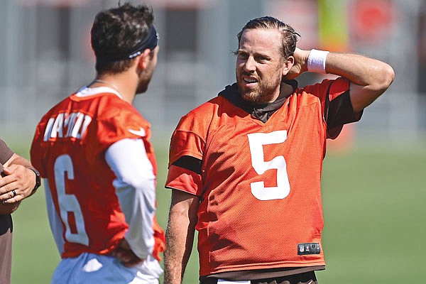 In this Aug. 24 file photo, Browns quarterback Case Keenum (5) talks with Baker Mayfield during practice in Berea, Ohio.