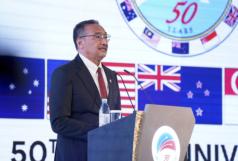 In this photo released by Malaysia Defense Ministry, Malaysian Defense Minister Hishammuddin Hussein speaks during the opening of the Five Power Defense Arrangements (FPDA) meeting in Kuala Lumpur, Malaysia, Thursday, Oct. 21, 2021. Australia and Britain are defending their nuclear submarine deal with the U.S. amid concerns it could escalate tensions in the region and spark an arms race. (Malaysia Defense Ministry via AP)