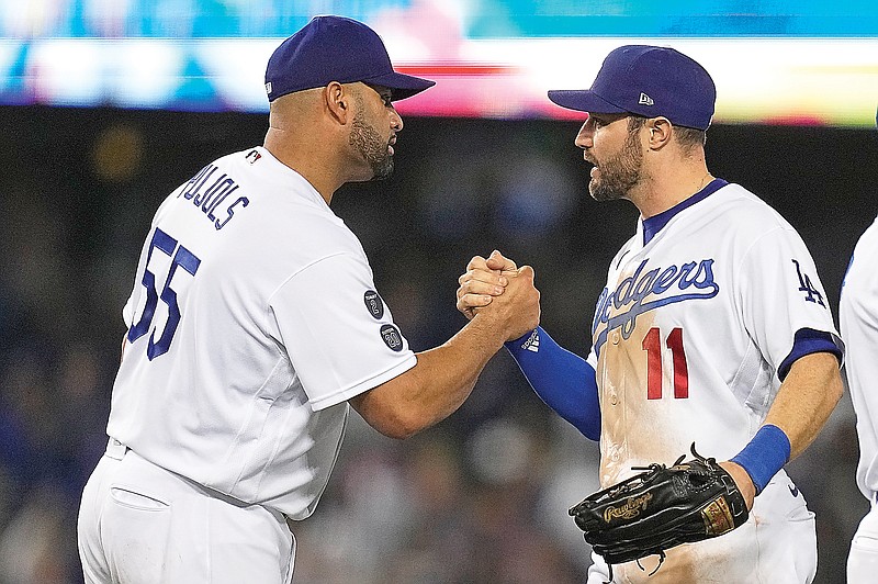 Albert Pujols congratulates Dodgers teammate AJ Pollock after Thursday's Game 5 of the National League Championship Series against the Braves in Los Angeles.
