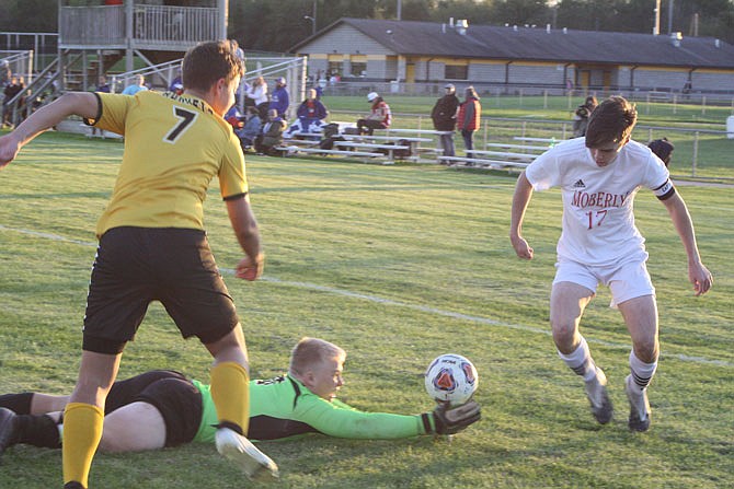 Senior goalkeeper Joey Anderson dives for the ball Thursday to rob Moberly of a possession in Fulton's 5-1 Senior Night win against the Spartans. Anderson was one of six seniors to be honored after the varsity game, and he and the other seniors were factors during the game.