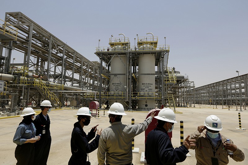 <p>AP</p><p>Saudi Aramco engineers and journalists look at the Hawiyah Natural Gas Liquids Recovery Plant on June 28 in Hawiyah, in the Eastern Province of Saudi Arabia. One of the world’s largest oil producers, Saudi Arabia, announced on Saturday it aims to reach “net zero” greenhouse gas emissions by 2060, joining more than 100 countries in a global effort to try and curb man-made climate change.</p>