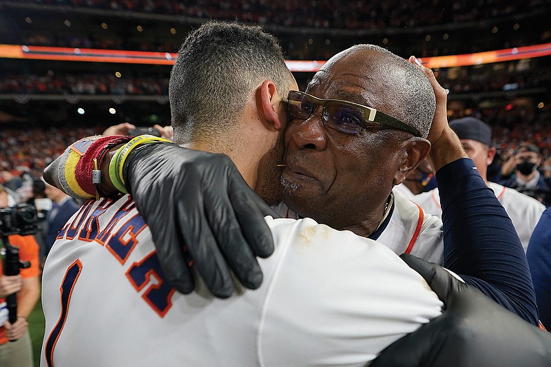 Astros manager Dusty Baker Jr. and shortstop Carlos Correa celebrate their win against the Boston Red Sox in Froday's Game 6 the ALCS Friday in Houston. The Astros won 5-0 to advance to the World Series.