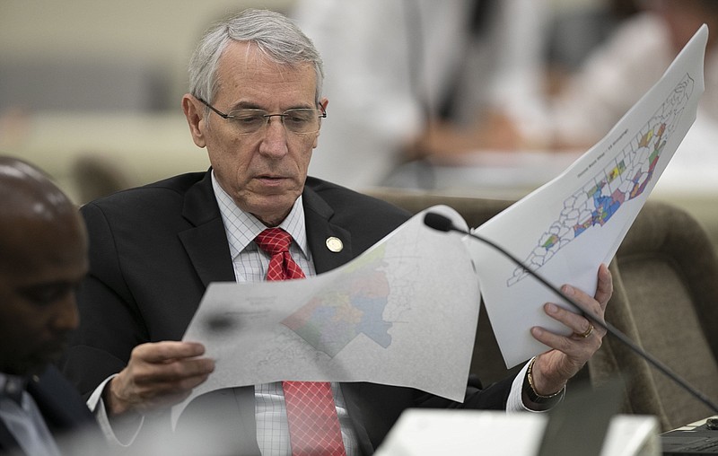FILE - In this Sept. 12, 2019, file photo, state Rep. John Szoka, of Fayetteville, looks over a redistricting map during a committee meeting at the Legislative Office Building in Raleigh, N.C. After lawsuits alleging racial gerrymandering, Republicans drawing legislative redistricting maps in Texas, Ohio and North Carolina this year say they won't use racial or partisan data in making their determinations. (Robert Willett/The News & Observer via AP)