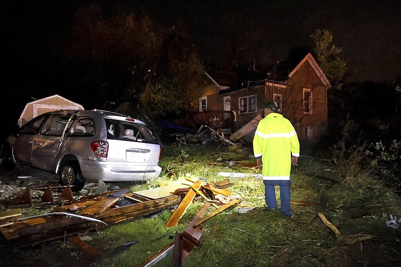 Jeff Schroeder, from Anna, Illinois, looks at a the debris strewn around a house in his sister's neighborhood in St. Mary, Mo., after a tornado hit the area on Sunday, Oct. 24, 2021. Schroeder was coming to pick up his sister whose house was extensively damaged. (David Carson/St. Louis Post-Dispatch via AP)