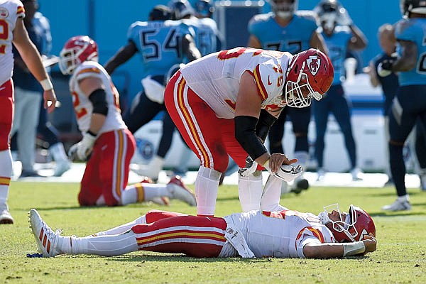 Chiefs quarterback Patrick Mahomes is helped up by Mike Remmers after Mahomes was hit in the second half of Sunday's game against the Titans in Nashville, Tenn.