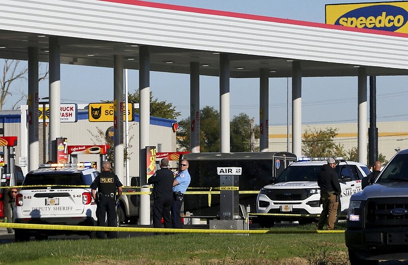 Police investigate the scene of a shooting on Tuesday, Oct. 26, 2021, at the Speedway gas station in Pontoon Beach, Illinois. Authorities say a man shot and fatally wounded a police officer Tuesday at the station. (Christian Gooden/St. Louis Post-Dispatch via AP)