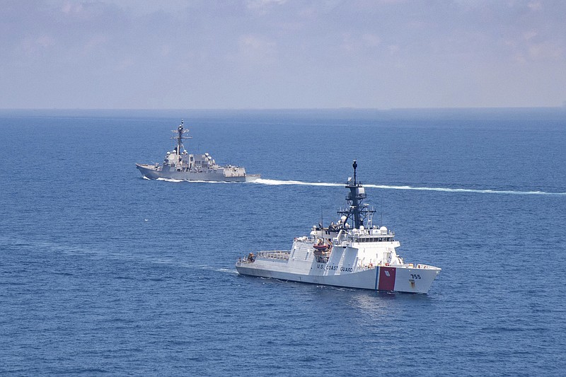 FILE - In this Aug. 27, 2021, file photo provided by U.S. Coast Guard, Legend-class U.S. Coast Guard National Security Cutter Munro (WMSL 755) transits the Taiwan Strait during a routine transit with Arleigh Burke class guided-missile destroyer USS Kidd (DDG 100). The United States and China are stepping up their war of words over Taiwan in a long-simmering dispute that has significant implications for the power dynamic in the Indo-Pacific and beyond. (U.S. Coast Guard via AP, File)