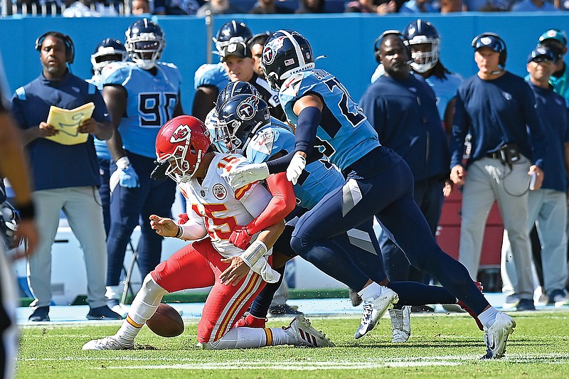 Chiefs quarterback Patrick Mahomes fumbles the ball as he is hit by Titans free safety Kevin Byard (31) in the first half of Sunday afternoon's game in Nashville, Tenn.